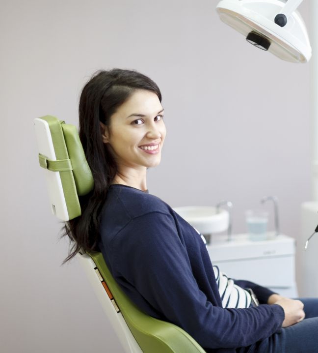 Woman in dental office smiling