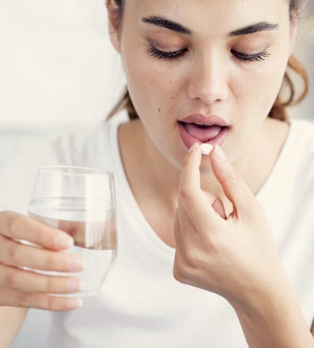 Woman taking a sedation dentistry pill