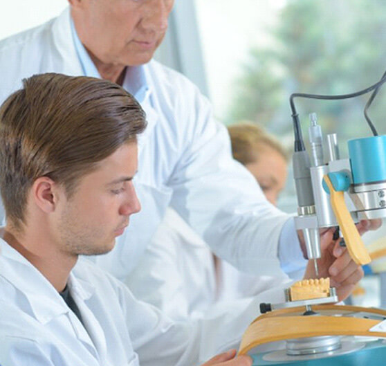 a dental lab technician working on constructing dentures 