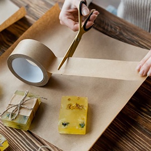 Person using scissors to cut tape