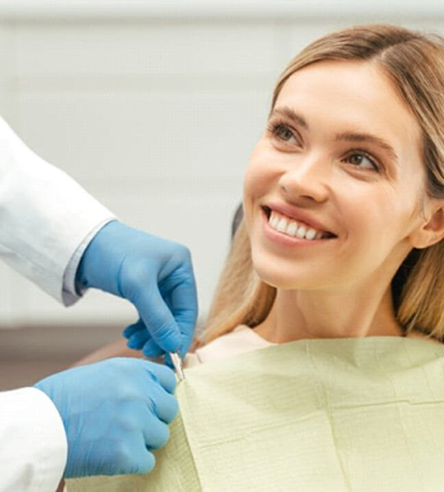 a patient smiling before undergoing dental treatment