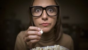 a person eating popcorn