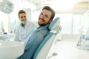 a patient smiling while visiting his dentist for preventive care 